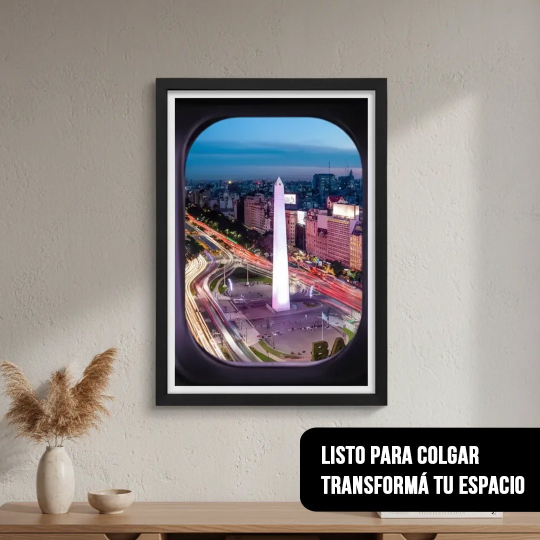 Cuadro decorativo vertical con fotografía de Buenos Aires desde la ventanilla de un avión con marco negro, colgado en una pared clara de living