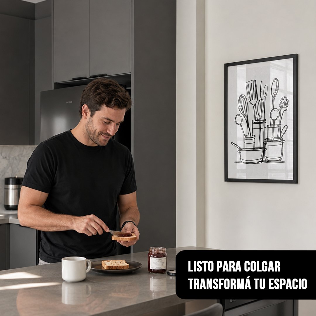 Cuadro vertical enmarcado en negro con ilustración de utensilios de cocina en línea negra sobre fondo blanco colgado en cocina moderna donde un hombre prepara tostadas